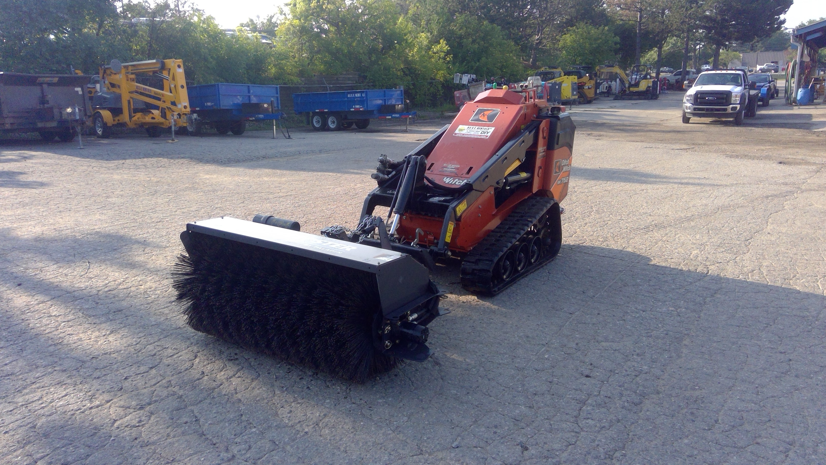 Rent the Sweeper Attachment for Mini Skid Steer AC&E Rentals